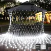 Outdoor patio area at dusk, decorated with white net lights draped over a gazebo and spread on the wooden deck. Produktbild-Vorschau