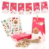 A collection of Christmas-themed advent calendar bags, stickers, twine, and clothespins arranged on a white background. Produktbild-Vorschau