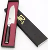 A Shun Santoku knife is presented in its packaging. Náhled obrázku produktu