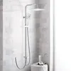 A modern shower system with a square rain showerhead and a handheld showerhead, mounted on a tiled wall. Anteprima dell’immagine prodotto