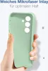 A hand holding a light green phone case. Produktbild-Vorschau