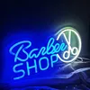 A neon sign for a barber shop, with the words "Barber Shop" and a pair of scissors. Podgląd zdjęcia produktu