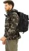 A man wearing a camouflage jacket and cargo pants is shown from the side, wearing a black backpack. Náhled obrázku produktu