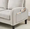 A close-up view of the armrest of a beige sofa, showing a pocket with a tablet and a magazine. Anteprima dell’immagine prodotto