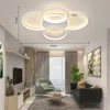 A modern living room with a ceiling lamp, sofa, chair, and TV. Voir les images du produit