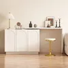 A white cabinet with arched doors and a white shelf above it, decorated with various objects and a gold stool in front of it. Podgląd zdjęcia produktu
