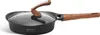 A black frying pan with a glass lid and wooden handles, shown on a white background. Produktbild-Vorschau