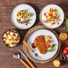 A table setting with various dishes, including a steak, fruit salad, and yogurt with fruit, suggesting a meal. Náhled obrázku produktu
