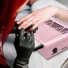 A person is getting their nails done, with a pink nail dust collector in the foreground. Anteprima dell’immagine prodotto