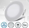 A white LED recessed light fixture is shown against a blurred background of a room. Náhled obrázku produktu