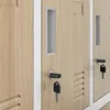 A close-up view of several wooden lockers with keys in the locks. Voir les images du produit
