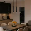 A modern kitchen and dining area with pendant lights over a dining table. Anteprima dell’immagine prodotto