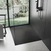 A modern bathroom with a black shower tray and a large window overlooking a garden. Náhľad obrázku produktu