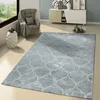 A modern living room with a gray rug, armchair, and a white cabinet. Produktbild-Vorschau