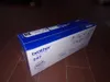 A Brother toner cartridge box is placed on a tiled floor. Voir les images du produit