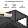 A hand is shown cleaning the glass top of a black rattan coffee table. Produktbild-Vorschau