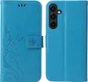 A blue flip phone case with a floral and butterfly design is shown open, displaying the inside and the camera cutout. Produktbild-Vorschau