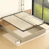 A disassembled bed frame with a slatted base shown above its base. Voir les images du produit