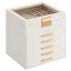 A white jewelry box with gold accents and a glass lid, shown against a white background. Produktbild-Vorschau