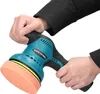 Hands holding a teal and black cordless car polisher with an orange foam pad. Produktbild-Vorschau