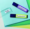 Two highlighters and a ruler are placed on top of colored paper. Produktbild-Vorschau