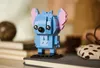 A LEGO BrickHeadz Stitch figure is displayed on a stack of books, with other objects blurred in the background. Anteprima dell’immagine prodotto