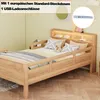A child's wooden bed with safety rails and a headboard featuring storage and lighting, shown in a bedroom setting. A small inset shows a USB charging port. Voir les images du produit