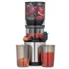 A slow juicer with fruits in the top chamber and juice in a beaker. Produktbild-Vorschau