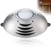 A silver, oval-shaped air purifier with vents and a central button. Produktbild-Vorschau