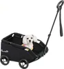 A small white dog wearing a pink and yellow striped shirt sits in a black pet stroller. Produktbild-Vorschau