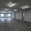 An empty industrial or commercial space with fluorescent lighting. Produktbild-Vorschau