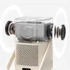 A close-up, cutaway view of a projector, highlighting its internal speakers and sound projection. Produktbild-Vorschau