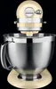 A cream-colored KitchenAid stand mixer with a silver bowl against a black background. Produktbild-Vorschau
