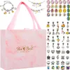 A gift set for making bracelets, including a pink marble patterned box and various charms and beads. Náhled obrázku produktu