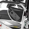 Close-up view of a mesh storage pouch attached to the armrest of a mobility aid, with a mobile phone inside the pouch. Náhľad obrázku produktu
