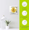 A clock with a lemon slice frozen in ice is displayed on a wall, with marketing information on the right side. Produktbild-Vorschau