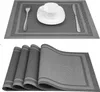 Two images showing placemats. The top image shows a single placemat with a cup, saucer, fork, and knife. The bottom image shows a stack of four placemats. Podgląd zdjęcia produktu