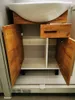 A bathroom cabinet with a sink, showing its open doors and drawer. Náhled obrázku produktu