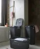 A bathroom scene with laundry baskets and a wooden ladder. Produktbild-Vorschau