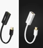 Two adapters, one black and one white, are shown against contrasting backgrounds. Voir les images du produit