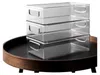 Three clear plastic storage containers are stacked on top of each other on a dark round tray. Náhled obrázku produktu