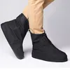 A person wearing tan pants and black shoe covers. Produktbild-Vorschau