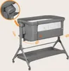 A baby crib with a stand, showing adjustable features. Produktbild-Vorschau