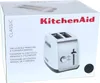 The image shows the front of a KitchenAid toaster box. Voir les images du produit