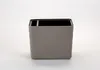 A single gray planter pot with horizontal ridges, shown against a white background. Náhled obrázku produktu
