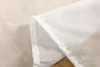 A close-up view of the hem and seam of a white sheer curtain. Produktbild-Vorschau