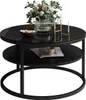 A round coffee table with a glass top and a lower shelf, decorated with a vase of flowers, a bowl of decorative items, and two candles in a holder. Produktbild-Vorschau