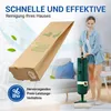 A woman is vacuuming a room with a green vacuum cleaner, while a large brown vacuum bag is prominently displayed in the foreground. There are also green leaves floating in the air. Produktbild-Vorschau
