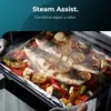 A close-up shot of a baking tray with fish and vegetables being cooked in an oven, with steam rising. Produktbild-Vorschau