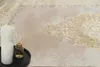 A close-up of a rug with decorative elements, alongside candles and a diffuser. Produktbild-Vorschau